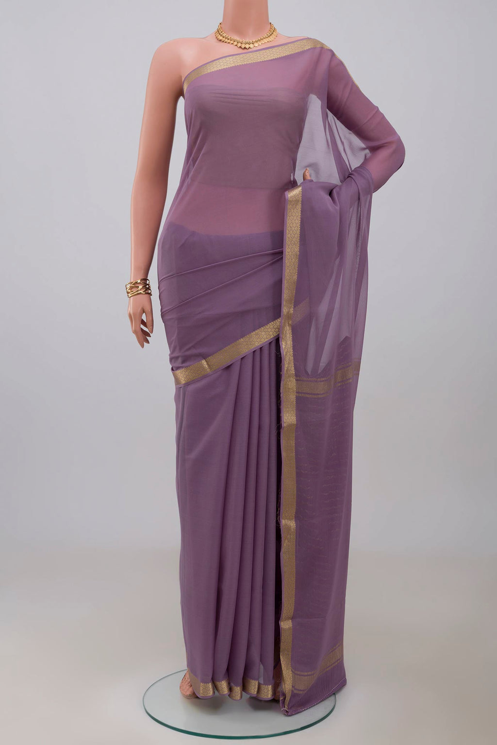 Lavender Georgette Saree with Plain Body and Zari Border.  displayed on a mannequin