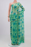 Pista Green Chiffon Saree with Printed design on the body and Zari Border.  displayed on a mannequin