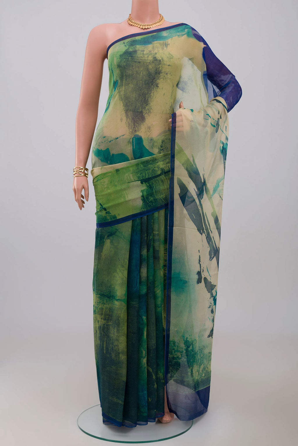 Green Chiffon Saree with Printed design on the body and Without Border.  displayed on a mannequin