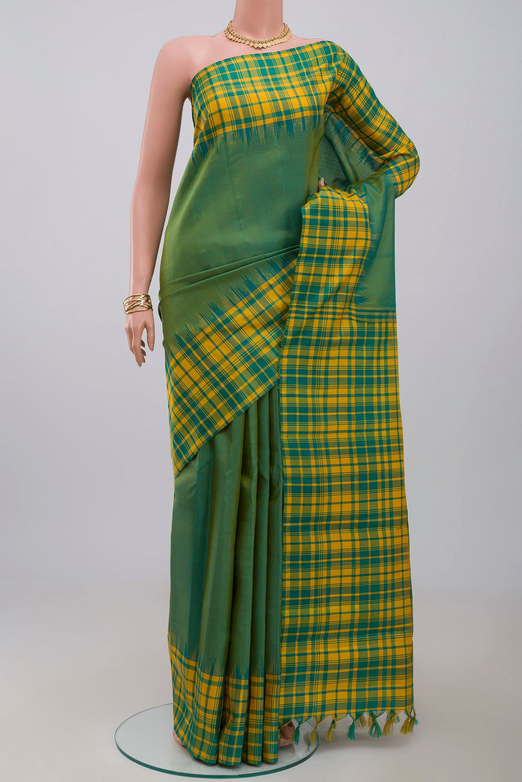 Green Gadwal Silk Saree with Plain Body and Checks Border.  displayed on a mannequin