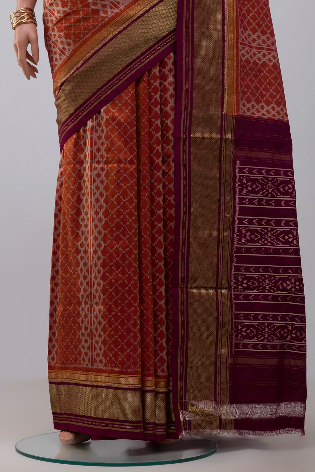 Pleats and pallu of Rust Pochampally Silk Saree with Ikat design on the body and Zari Border. 