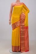 Yellow Kanchipuram Silk Saree with Zari Butta on the body and Zari Border.  displayed on a mannequin