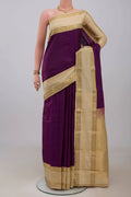 Purple Kanchipuram Silk Saree with Plain Body and Zari Border.  displayed on a mannequin