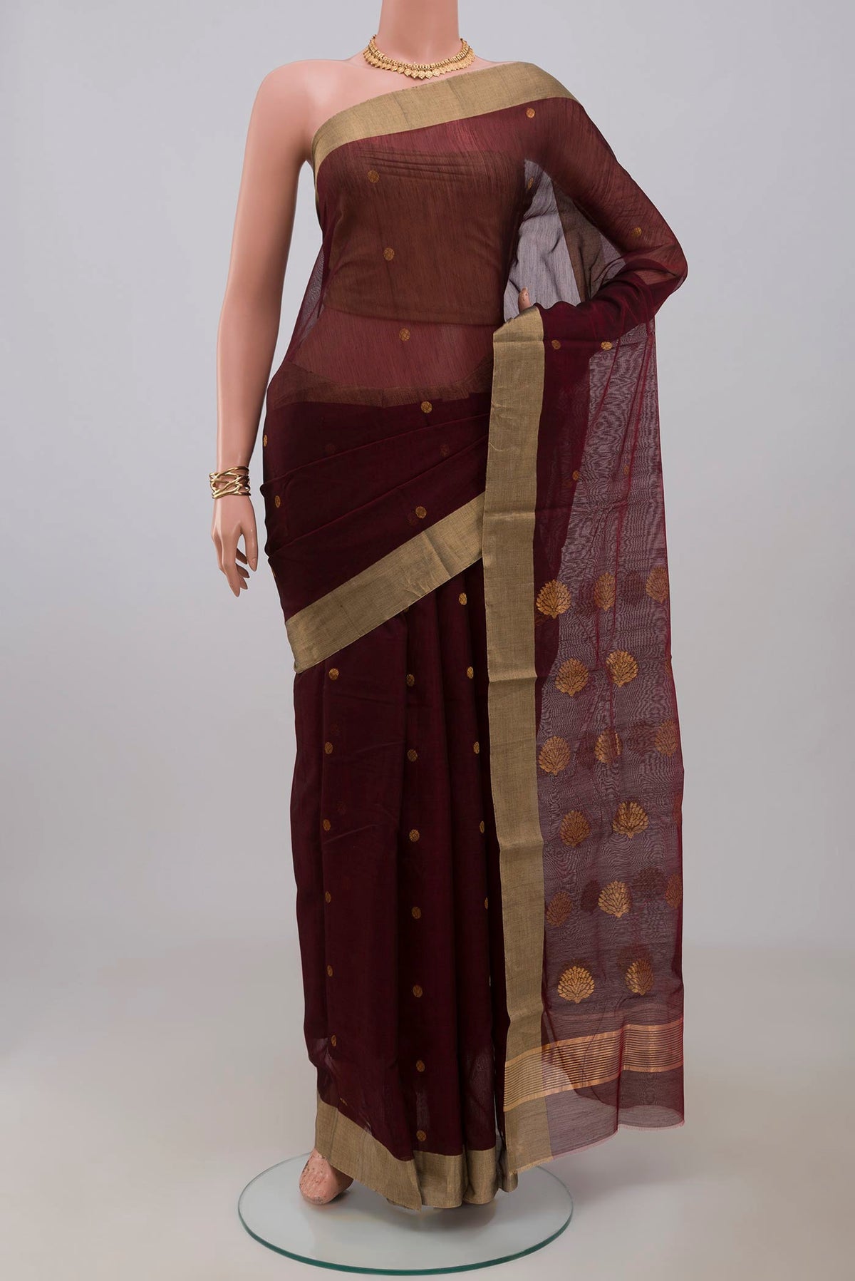 Maroon Chanderi Silk Cotton Saree with Zari Butta on the body and Zari Border.  displayed on a mannequin
