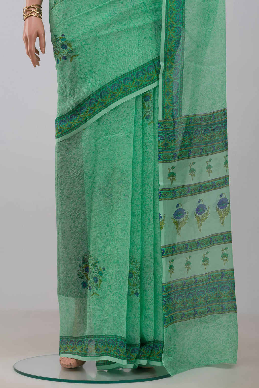Pleats and pallu of Sea Green Mysore Chiffon Saree with Printed design on the body and Printed Border. 