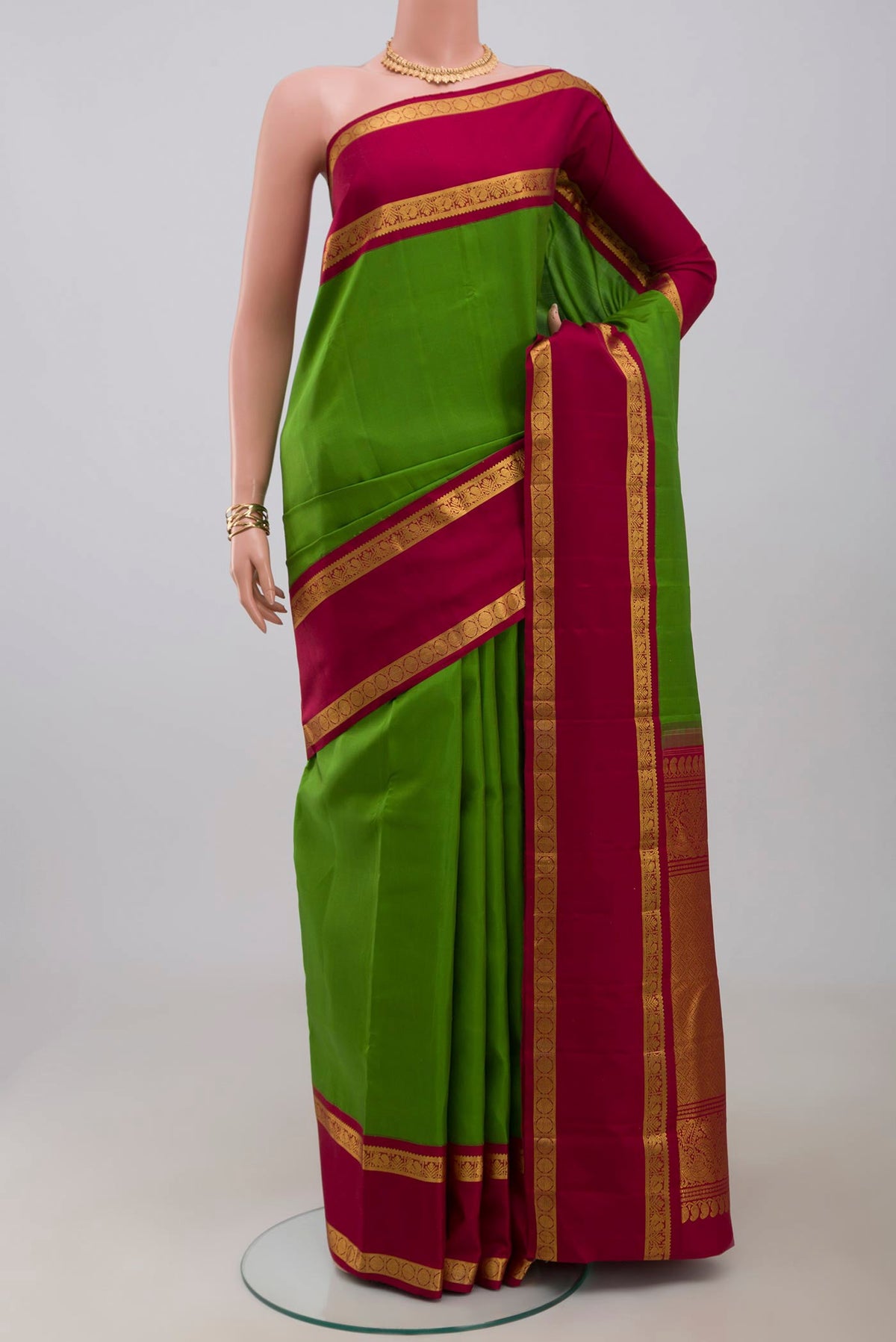 Pure Silk Pure Zari Green Kanchipuram Saree with Plain Body and Zari Border.  displayed on a mannequin