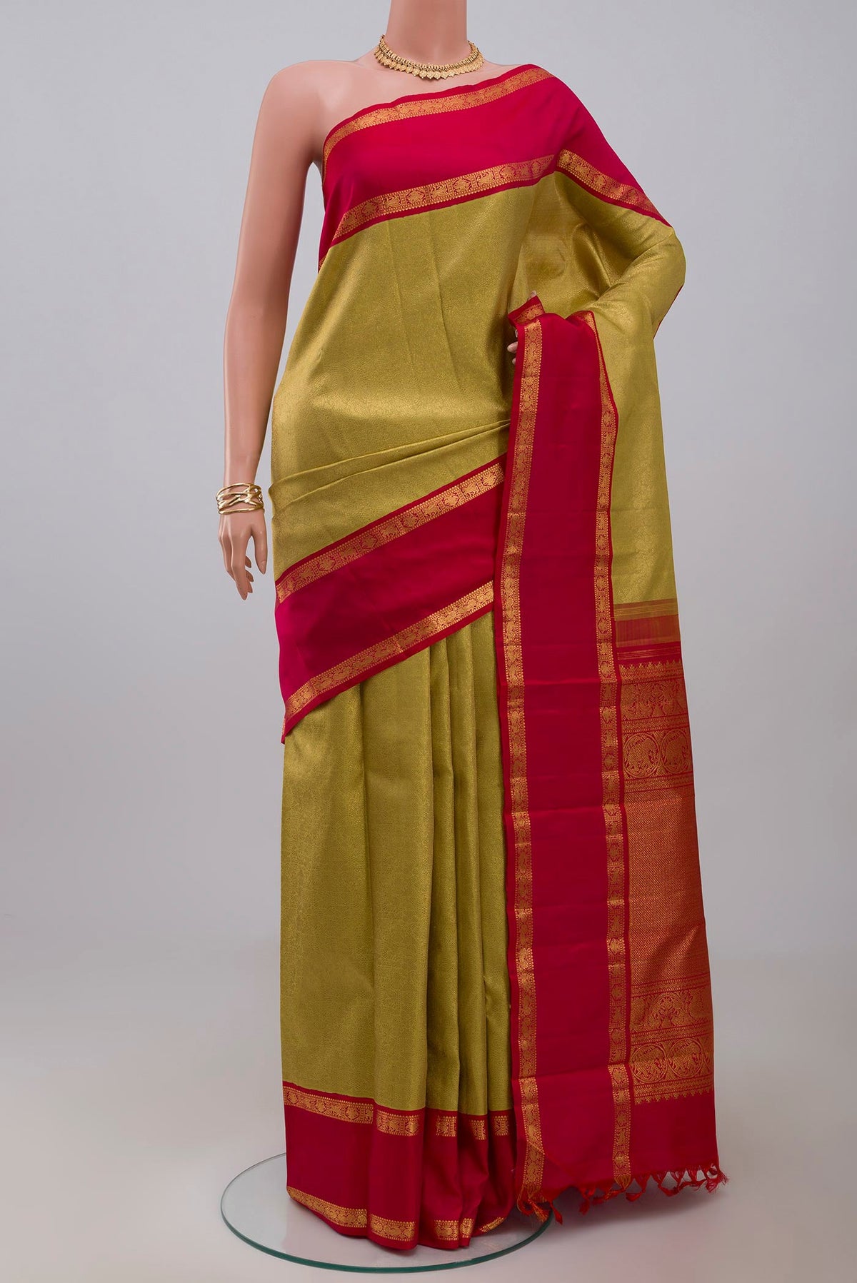 Golden Kanchipuram Saree with Zari Brocade on the body and Zari Border.  displayed on a mannequin