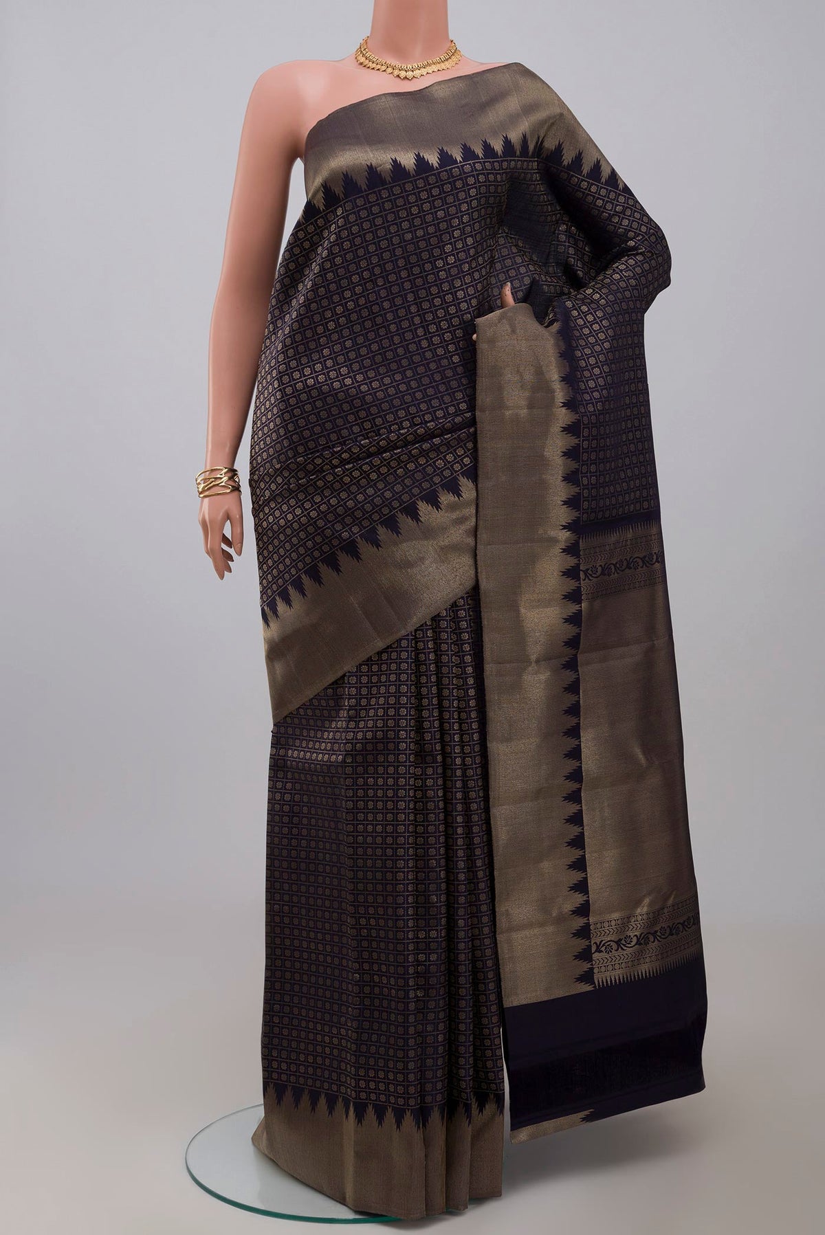 Blue Kanchipuram Silk Saree with Checked design on the body and Temple Border.  displayed on a mannequin