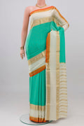 Turquoise Mysore Crepe Saree with Zari Butta on the body and Zari Border.  displayed on a mannequin