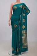 Blue Crepe Saree with Plain Body and Thin Zari Line.  displayed on a mannequin
