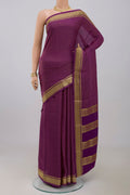 Purple Crepe Saree with Checked design on the body and Zari Border.  displayed on a mannequin