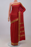 Red Crepe Saree with Checked design on the body and Zari Border.  displayed on a mannequin