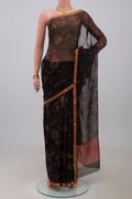 Black Chiffon Saree with Printed design on the body and Zari Border.  displayed on a mannequin
