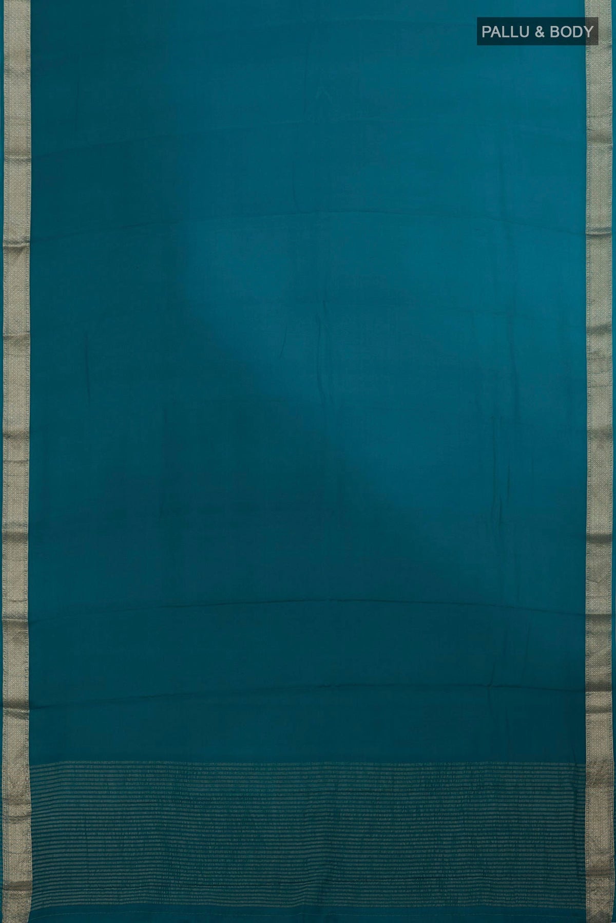 Flat view of Blue Mysore Chiffon Saree with Ombre design on the body and Zari Border. 