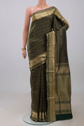 Green Soft Silk Saree with Zari Brocade on the body and Zari Border.  displayed on a mannequin