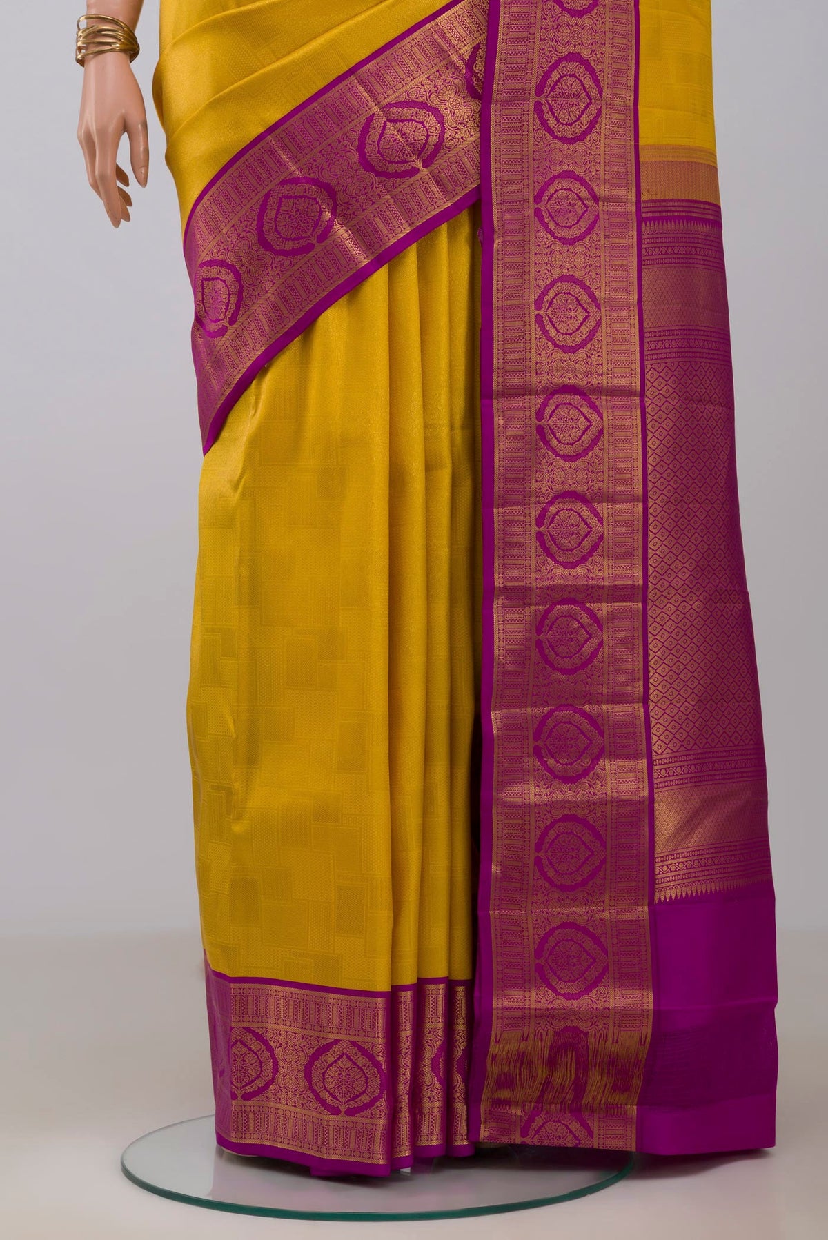 Pleats and pallu of Yellow Kanchipuram Silk Saree with Zari Brocade on the body and Zari Border. 