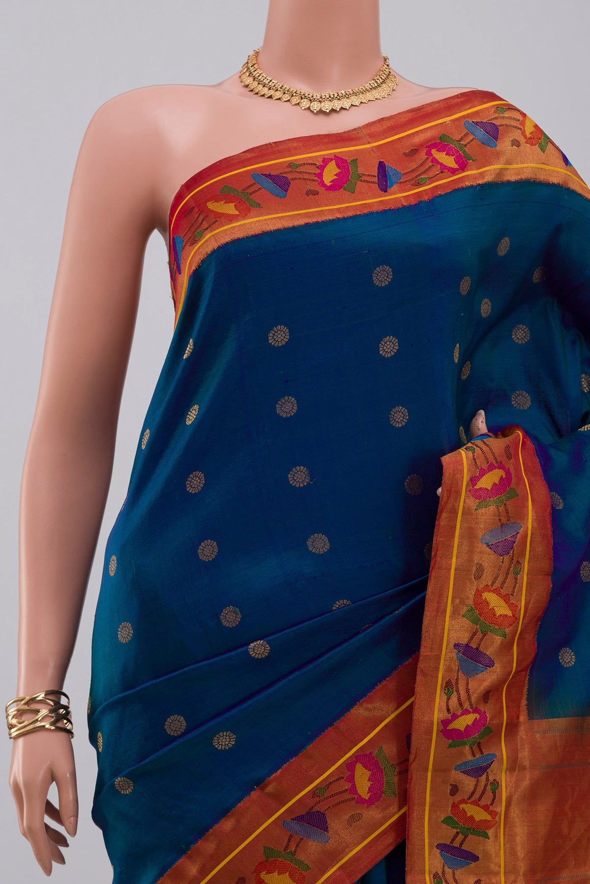 Border image of Blue Gadwal Silk Saree with Zari Butta on the body and Paithani Border. 