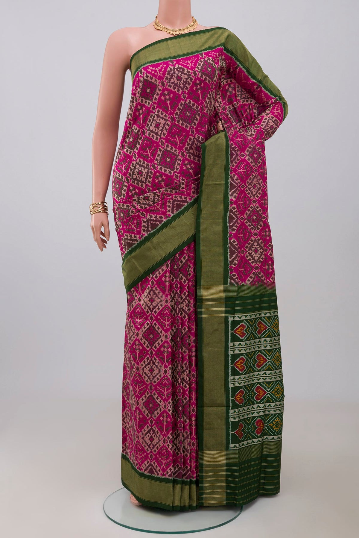 Pink Pochampally Saree with Ikat Print on the body and Zari Border.  displayed on a mannequin