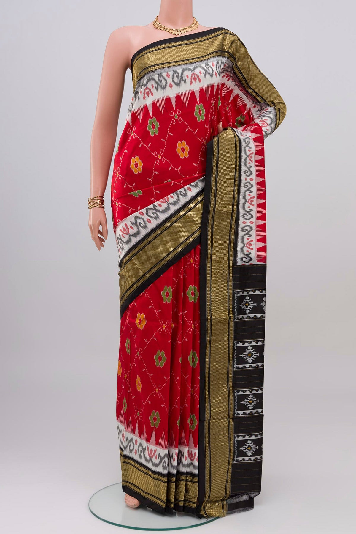 Red Pochampally Silk Saree with Ikat design on the body and Zari Border.  displayed on a mannequin