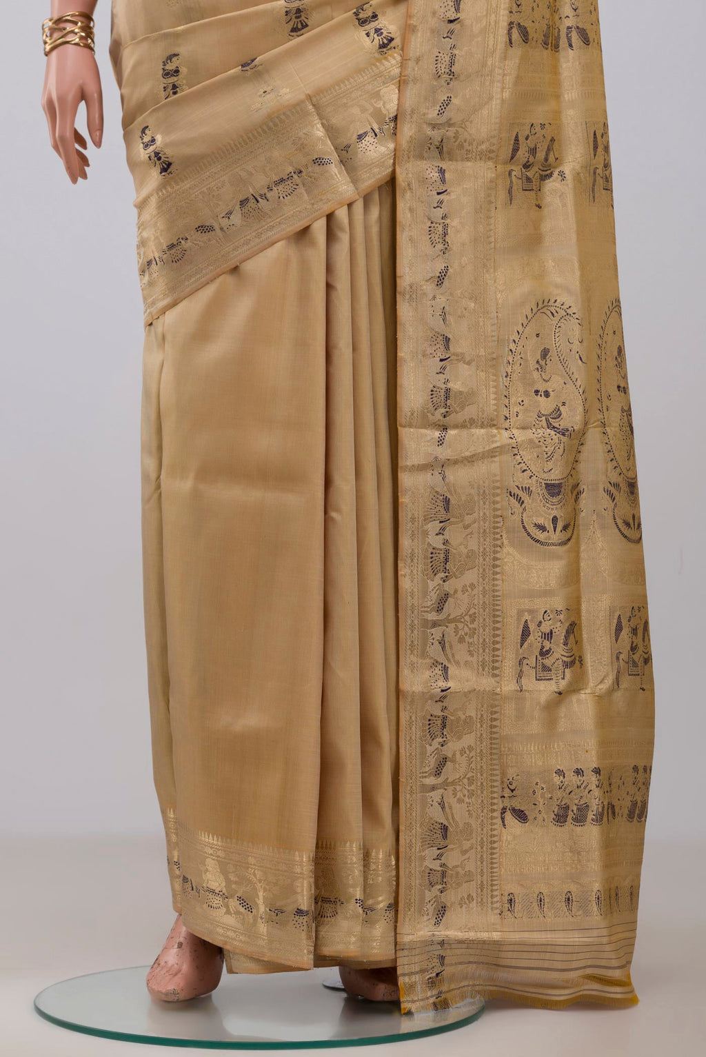 Pleats and pallu of Beige Baluchari Silk Saree with Zari And Thread Butta on the body and Zari Border. 