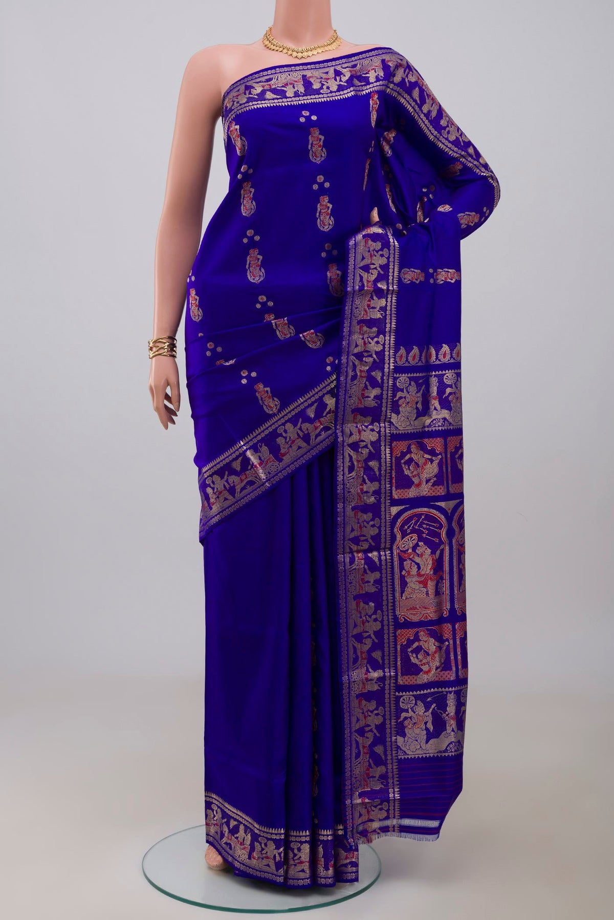 Blue Baluchari Silk Saree with Zari And Thread Butta on the body and Zari Border.  displayed on a mannequin