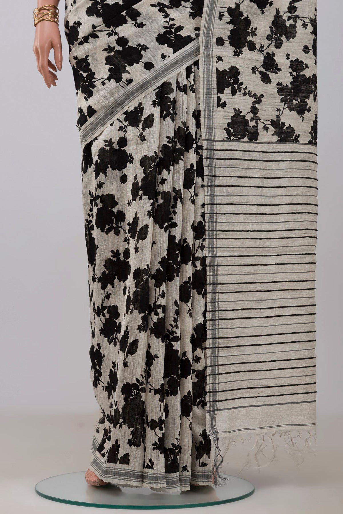 Pleats and pallu of Cream Tussar Silk Saree with Floral Print on the body and Plain Border. 