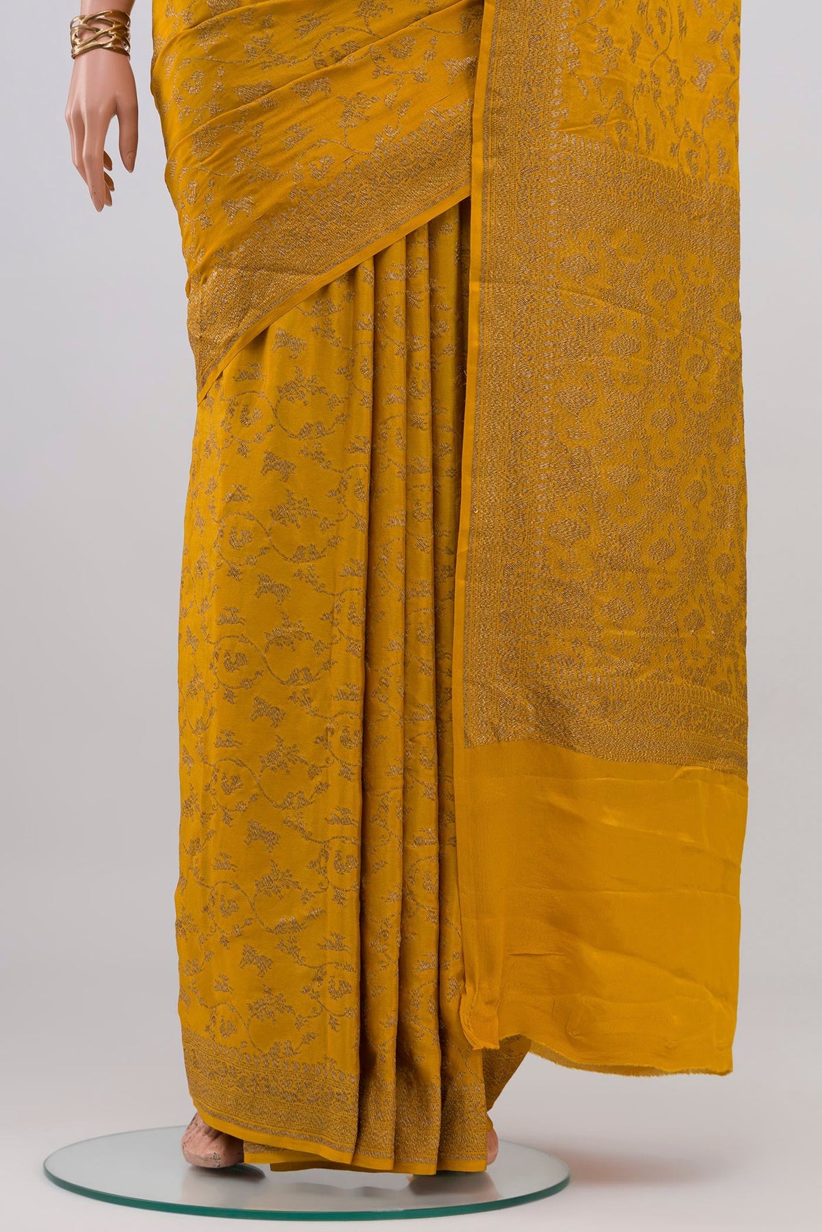 Pleats and pallu of Yellow Banarasi Georgette Saree with Zari Butta on the body and Zari Border. 