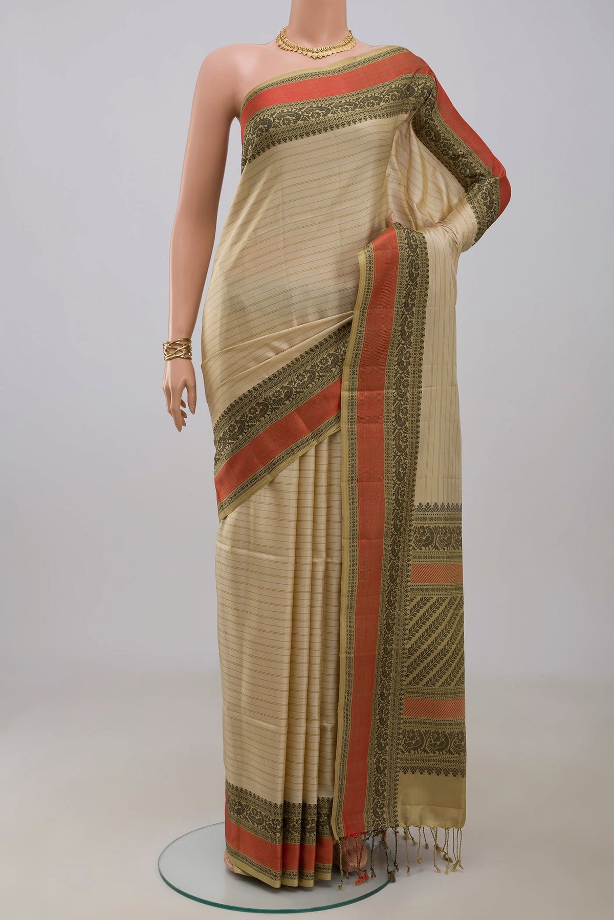 Cream Soft Silk Saree with Stripes on the body and Thread Border.  displayed on a mannequin