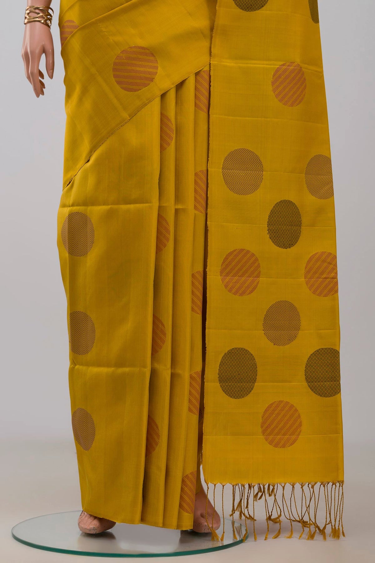 Pleats and pallu of Yellow Soft Silk Saree with Thread Butta on the body and Without Border. 