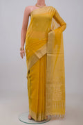 Yellow Silk Cotton Saree with Zari Butta on the body and Zari Border.  displayed on a mannequin