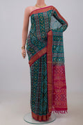 Green Silk Cotton Saree with Ikat Print on the body and Zari Border.  displayed on a mannequin