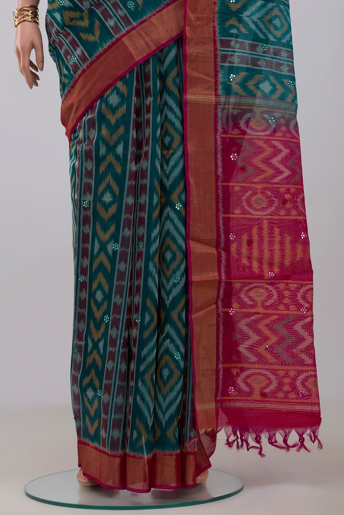 Pleats and pallu of Green Silk Cotton Saree with Ikat Print on the body and Zari Border. 