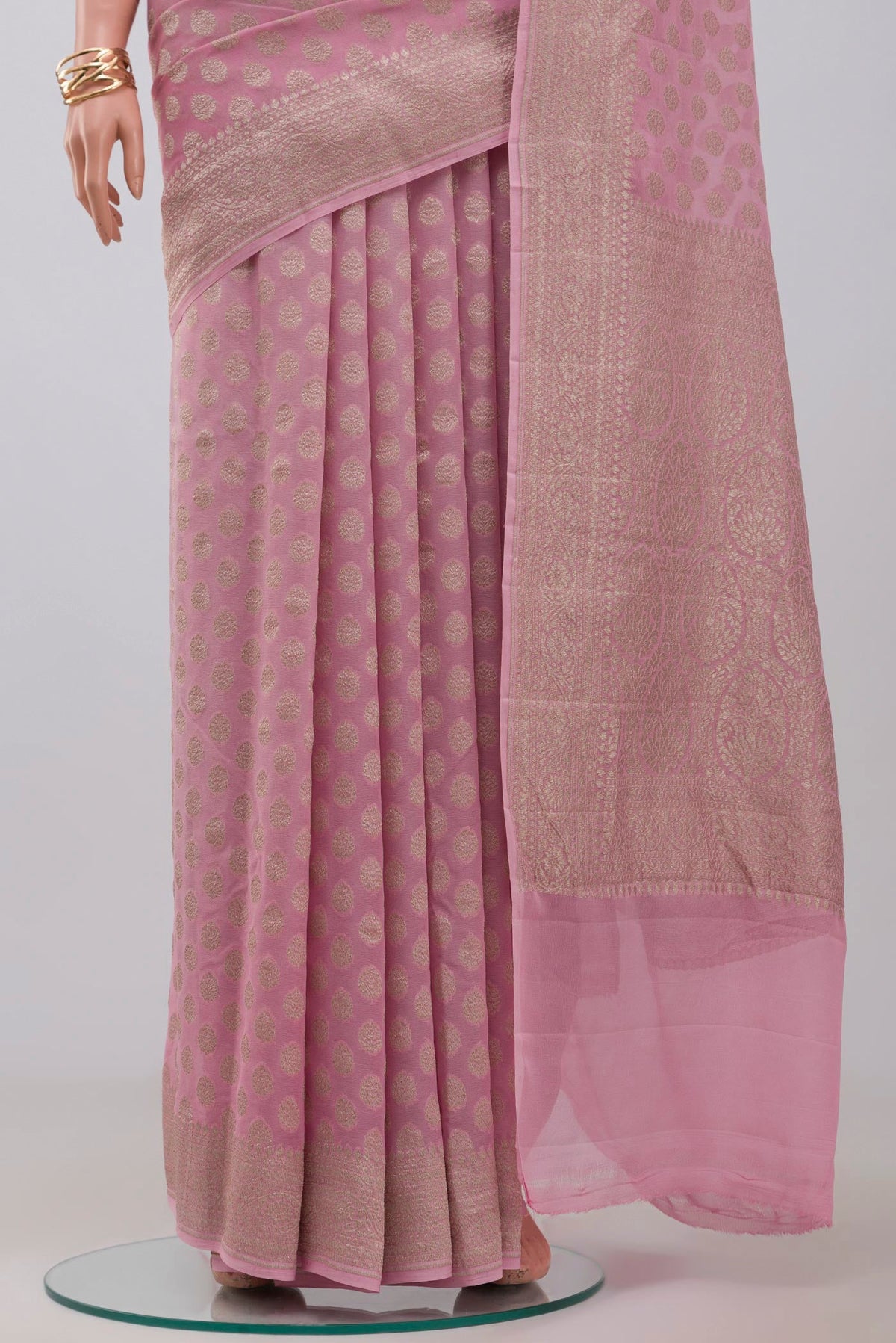 Pleats and pallu of Pink Georgette Saree with Fancy on the body and Zari Border. 