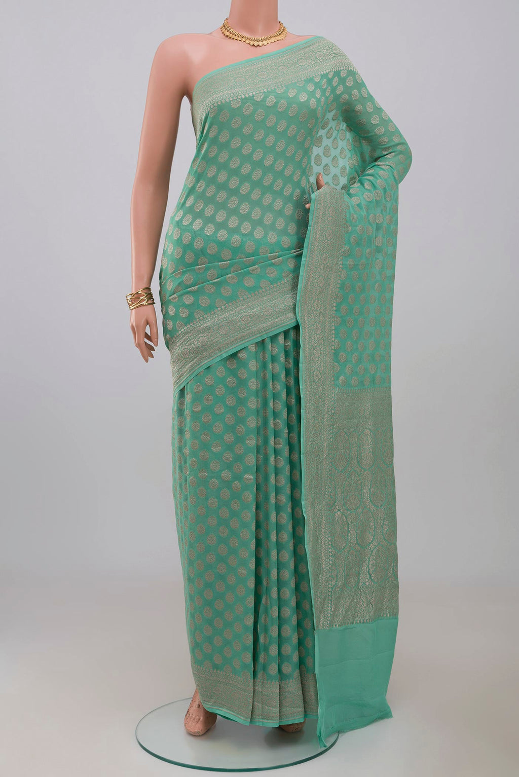 Blue Georgette Saree with Fancy on the body and Fancy Border.  displayed on a mannequin