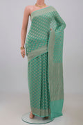 Blue Georgette Saree with Fancy on the body and Fancy Border.  displayed on a mannequin