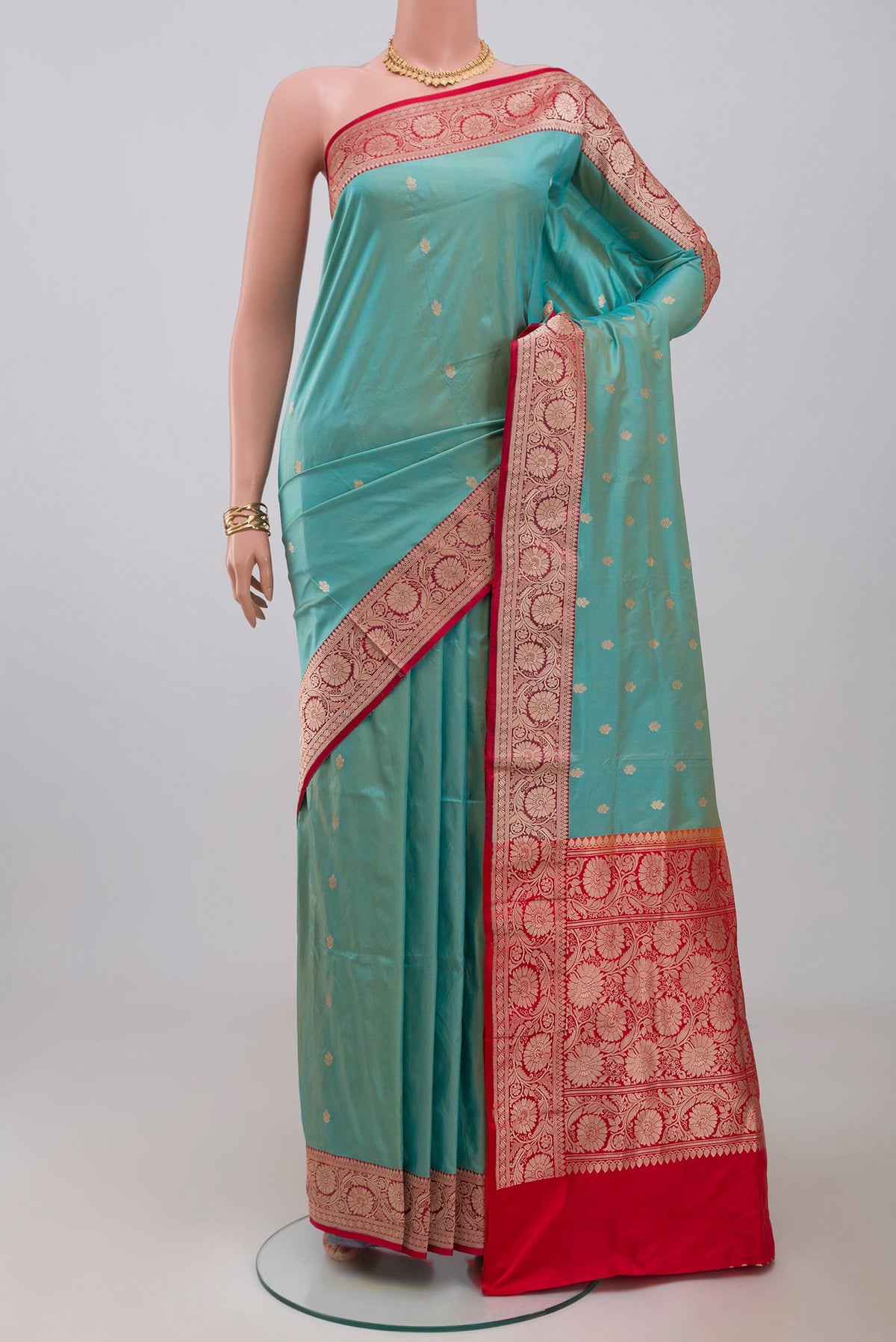Blue Banarasi Katan Silk Saree with Zari Butta on the body and Zari Border.  displayed on a mannequin
