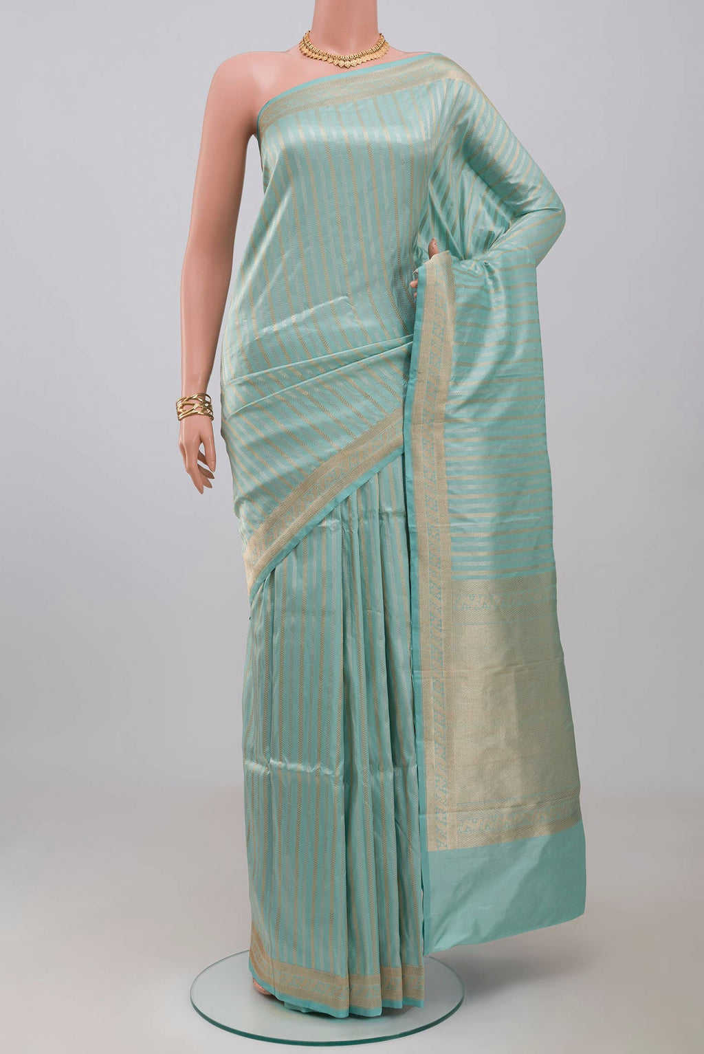 Sky Blue Banarasi Katan Silk Saree with Stripes on the body and Fancy Border.  displayed on a mannequin