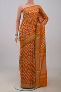 Rust Pochampally Saree with Ikat design on the body and Zari Border.  displayed on a mannequin