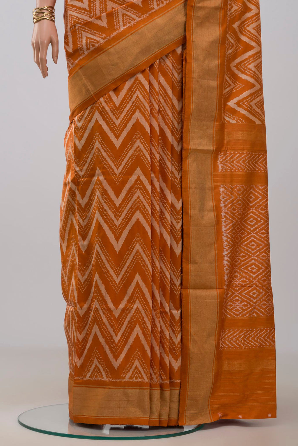 Pleats and pallu of Rust Pochampally Saree with Ikat design on the body and Zari Border. 