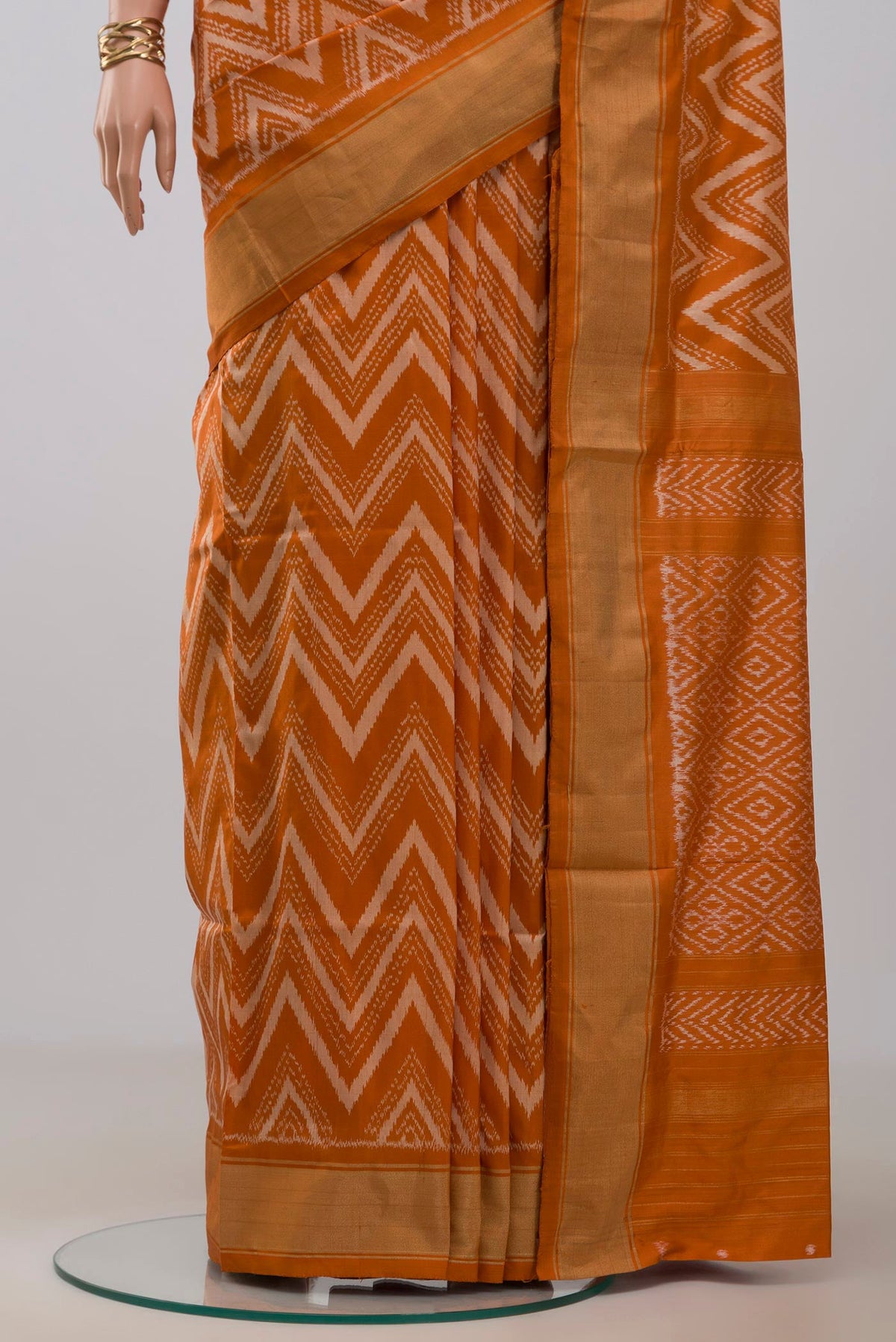 Pleats and pallu of Rust Pochampally Saree with Ikat design on the body and Zari Border. 