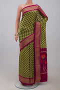 Green Pochampally Silk Saree with Ikat design on the body and Zari Border.  displayed on a mannequin