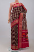 Brown Pochampally Silk Saree with Ikat design on the body and Zari Border.  displayed on a mannequin