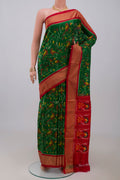Green Pochampally Silk Saree with Ikat design on the body and Zari Border.  displayed on a mannequin