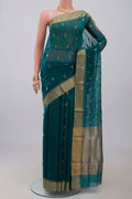 Green Chanderi Silk Cotton Saree with Zari Butta on the body and Zari Border.  displayed on a mannequin