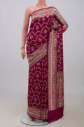 Burgundy Banarasi Silk Saree with Zari And Thread Butta on the body and Zari Border.  displayed on a mannequin