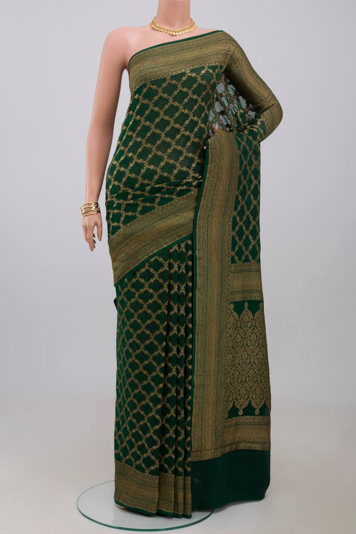Green Georgette Saree with Fancy on the body and Zari Border.  displayed on a mannequin