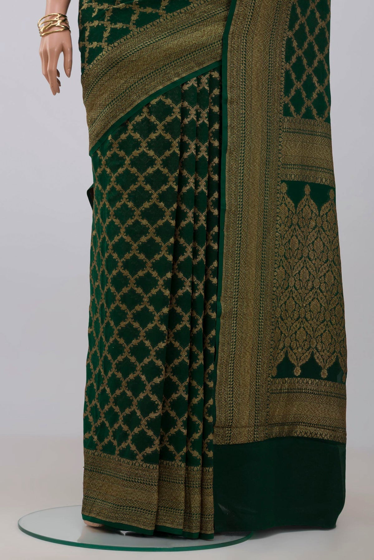 Pleats and pallu of Green Georgette Saree with Fancy on the body and Zari Border. 