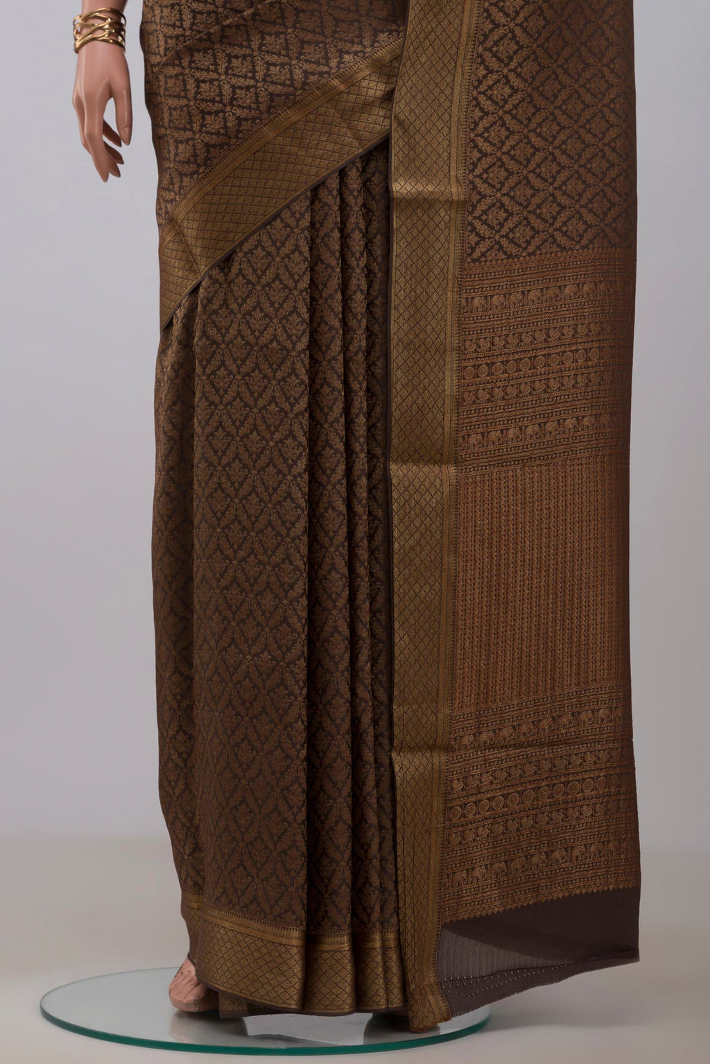 Pleats and pallu of Brown Mysore Crepe Saree with Zari Brocade on the body and Zari Border. 