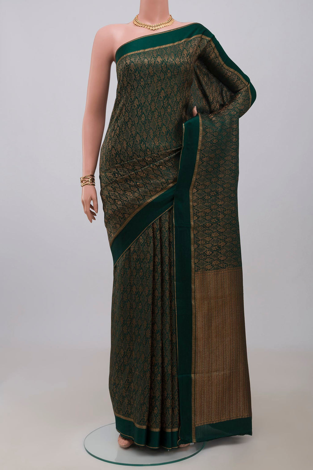 Bottle Green Mysore Crepe Saree with Zari Brocade on the body and Thin Zari Line.  displayed on a mannequin