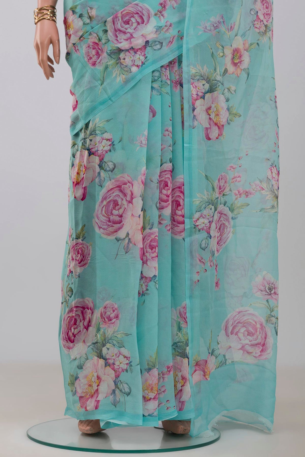 Pleats and pallu of Blue Chiffon Saree with Printed design on the body and Without Border. 